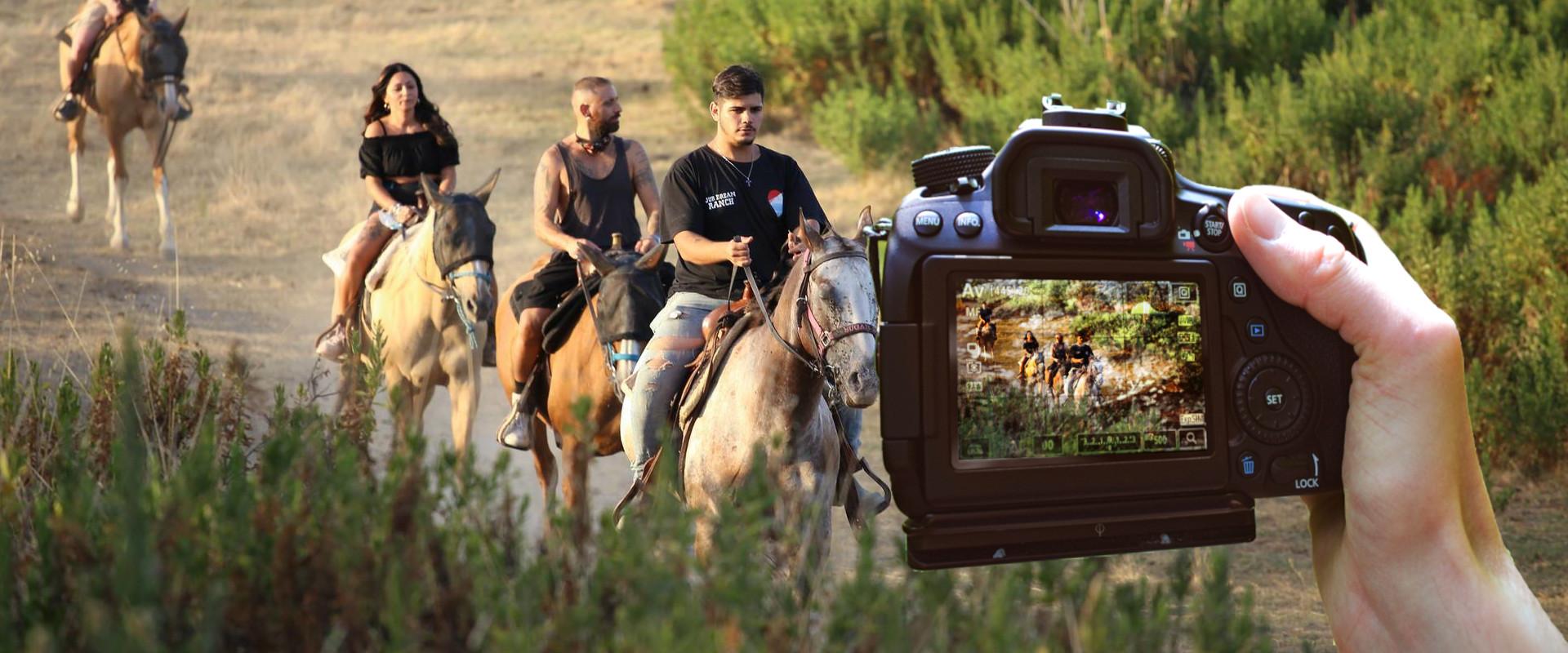 Photographer shooting photos at people riding horse